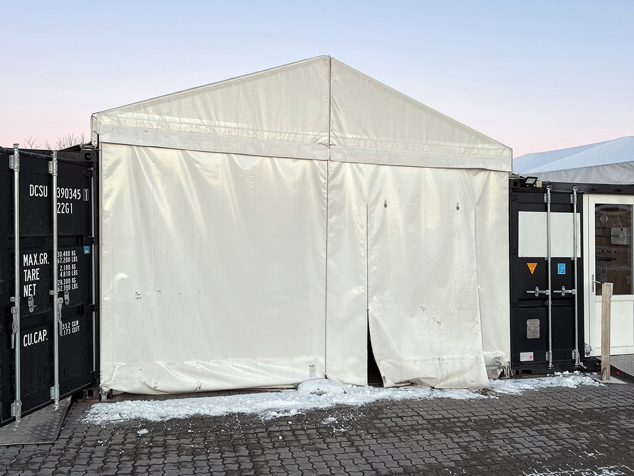 Cover tent for setting up between two 20-ft containers.